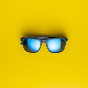 Fashion sunglasses on yellow background.