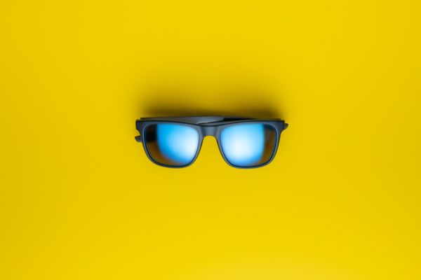 Fashion sunglasses on yellow background.